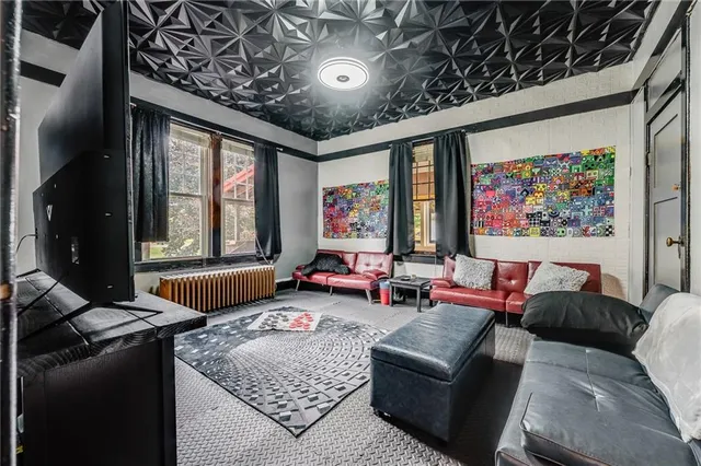 a living room with furniture and a ceiling fan