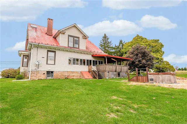 a front view of a house with a garden and yard