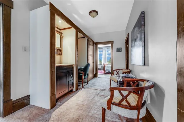 a living room with furniture and kitchen view