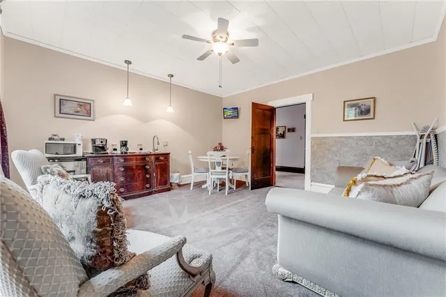 a bedroom with a bed couch and dresser