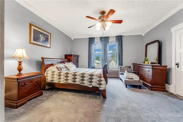 a bedroom with furniture and a rug