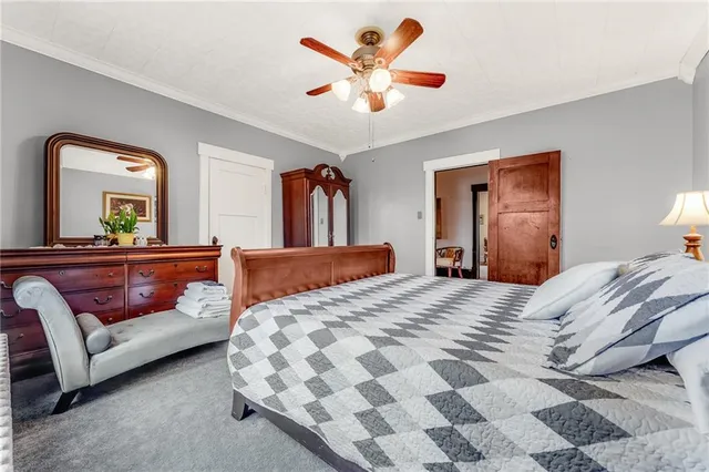 a bedroom with a bed and a mirror