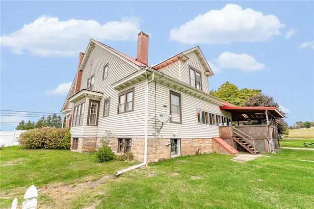 a front view of a house with a garden and plants