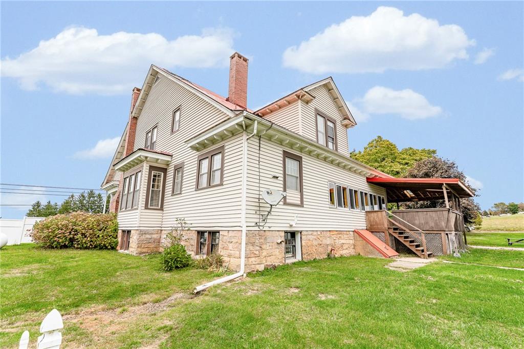 539 Main Street Addison, PA 15411 - Photo 5 of 50 a front view of a house with a garden and plants