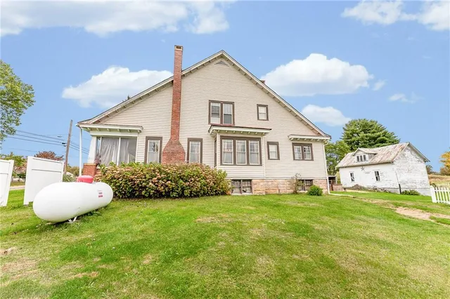 a view of a house with backyard and porch