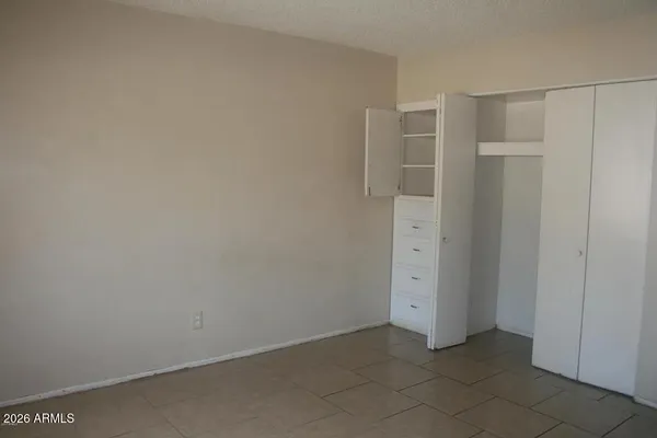 an empty room with closet area