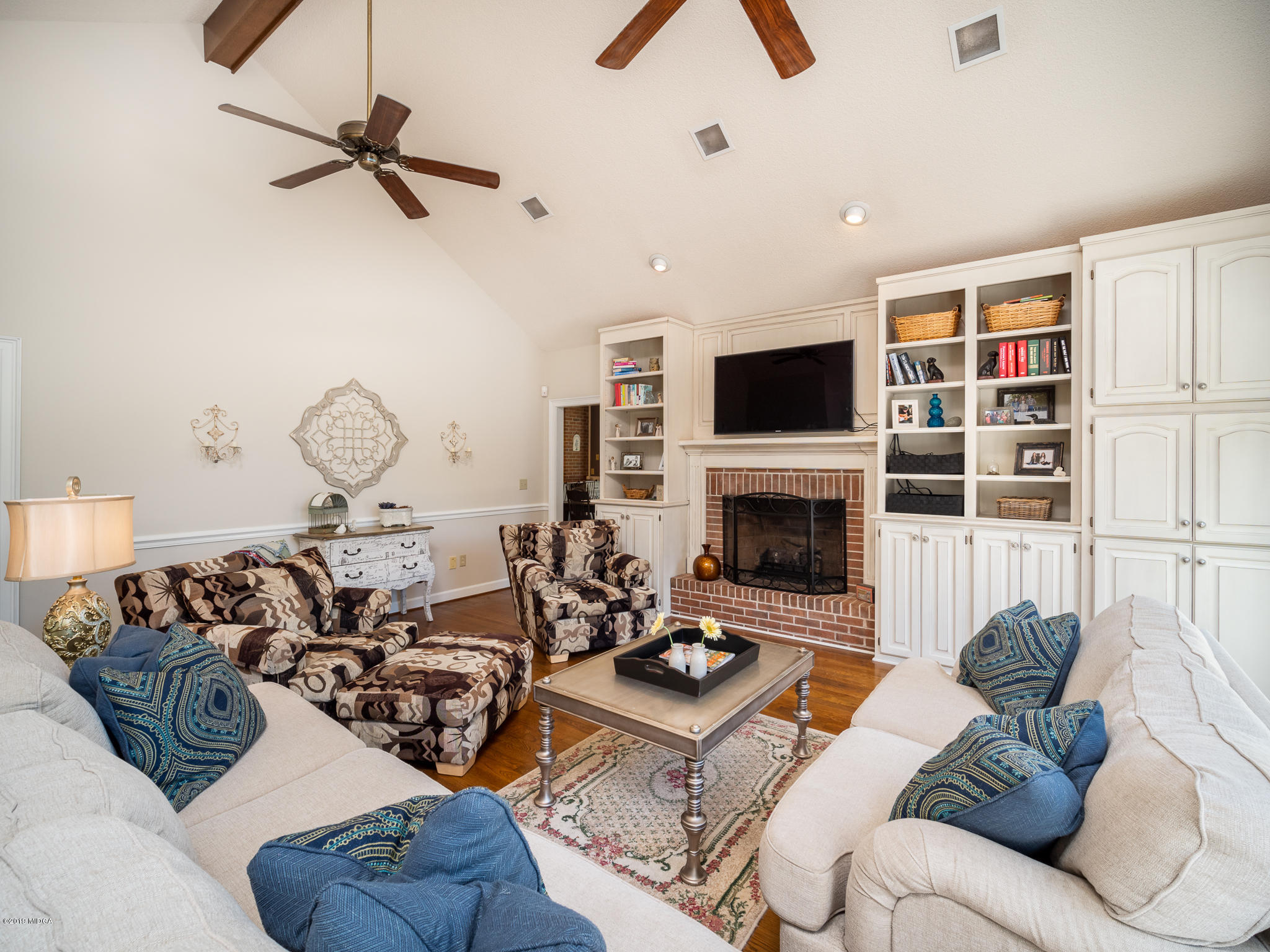 241 Country Creek Road Macon, GA 31220 - Photo 16 of 26 a living room with furniture a fireplace and a flat screen tv