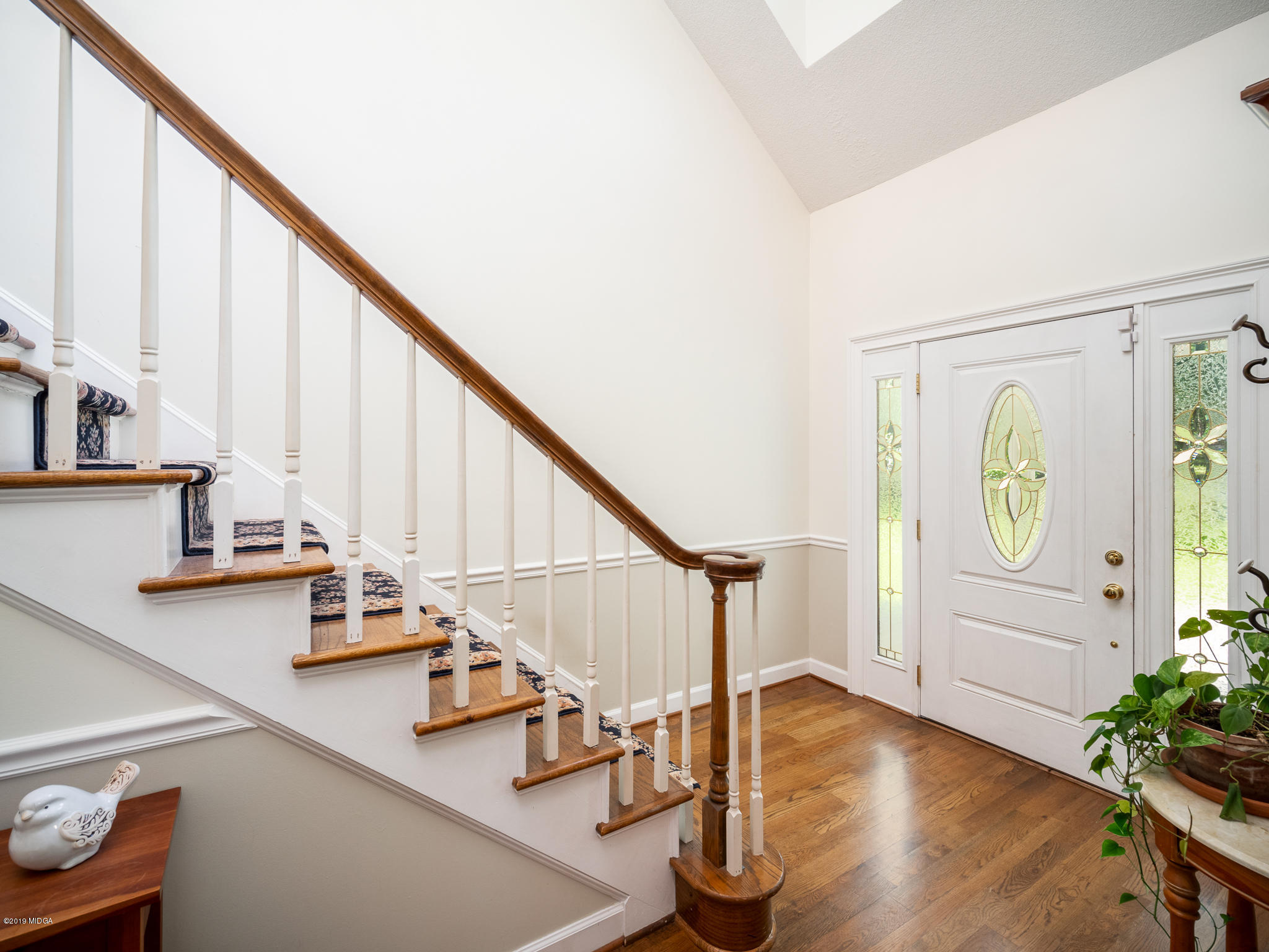 241 Country Creek Road Macon, GA 31220 - Photo 19 of 26 a view of staircase with lots of frames on wall and a potted plant