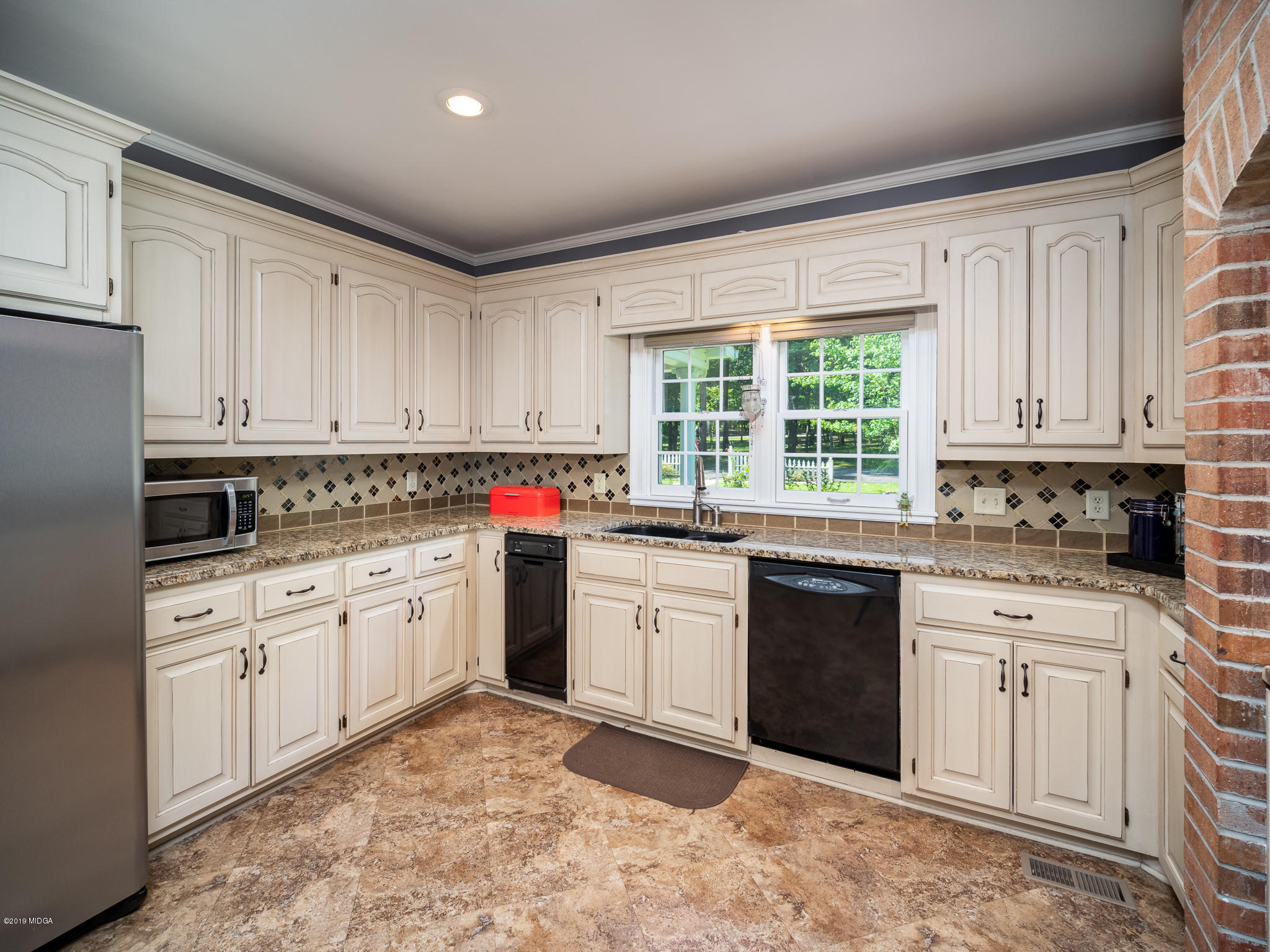 241 Country Creek Road Macon, GA 31220 - Photo 3 of 26 a kitchen with granite countertop white cabinets sink and white appliances