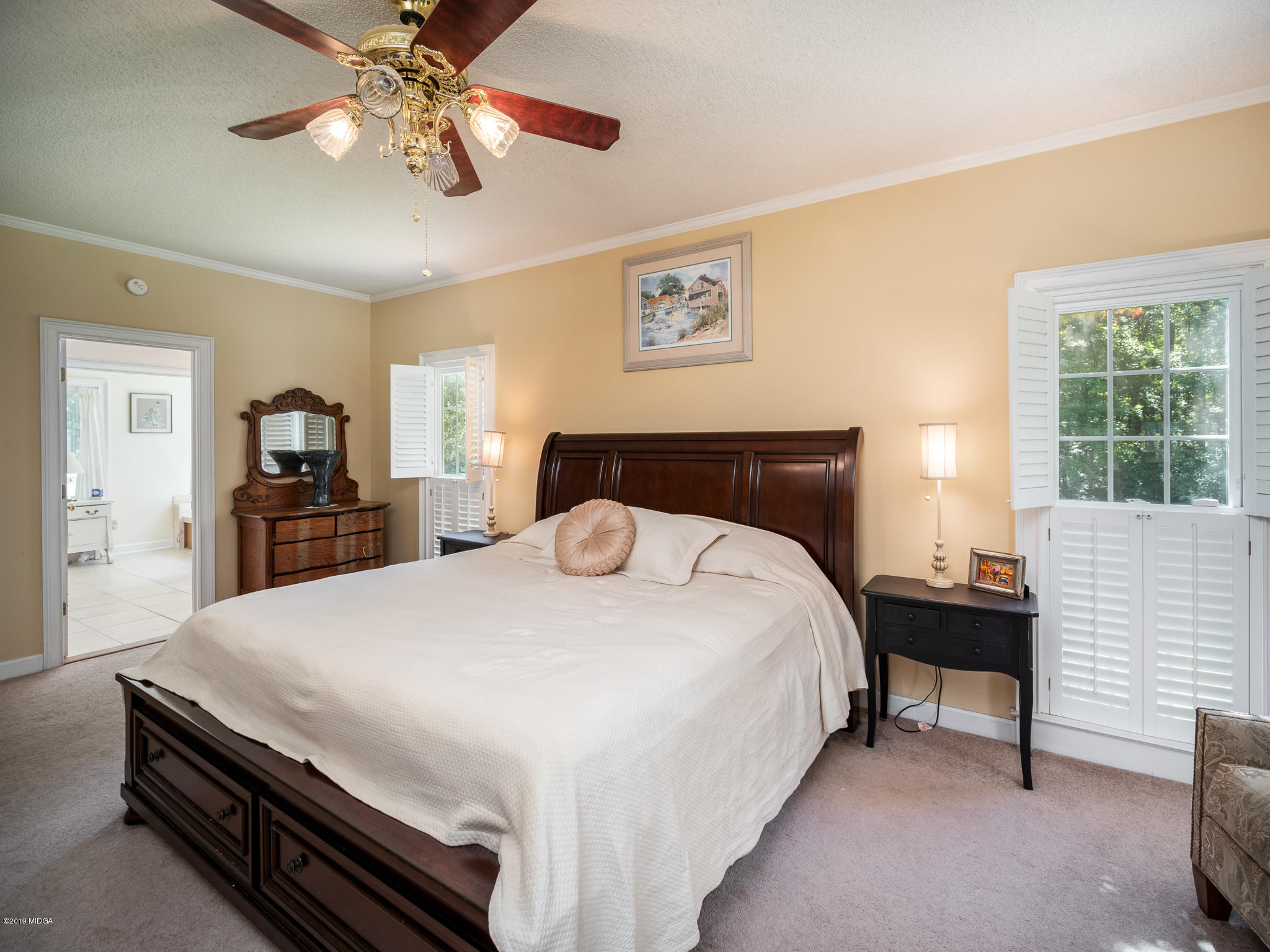 241 Country Creek Road Macon, GA 31220 - Photo 21 of 26 a bedroom with a bed and a chandelier
