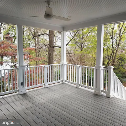 a large kitchen with stainless steel appliances granite countertop a stove a sink dishwasher a refrigerator and white cabinets with wooden floor