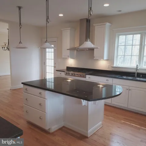 a metallic refrigerator freezer sitting inside of a kitchen