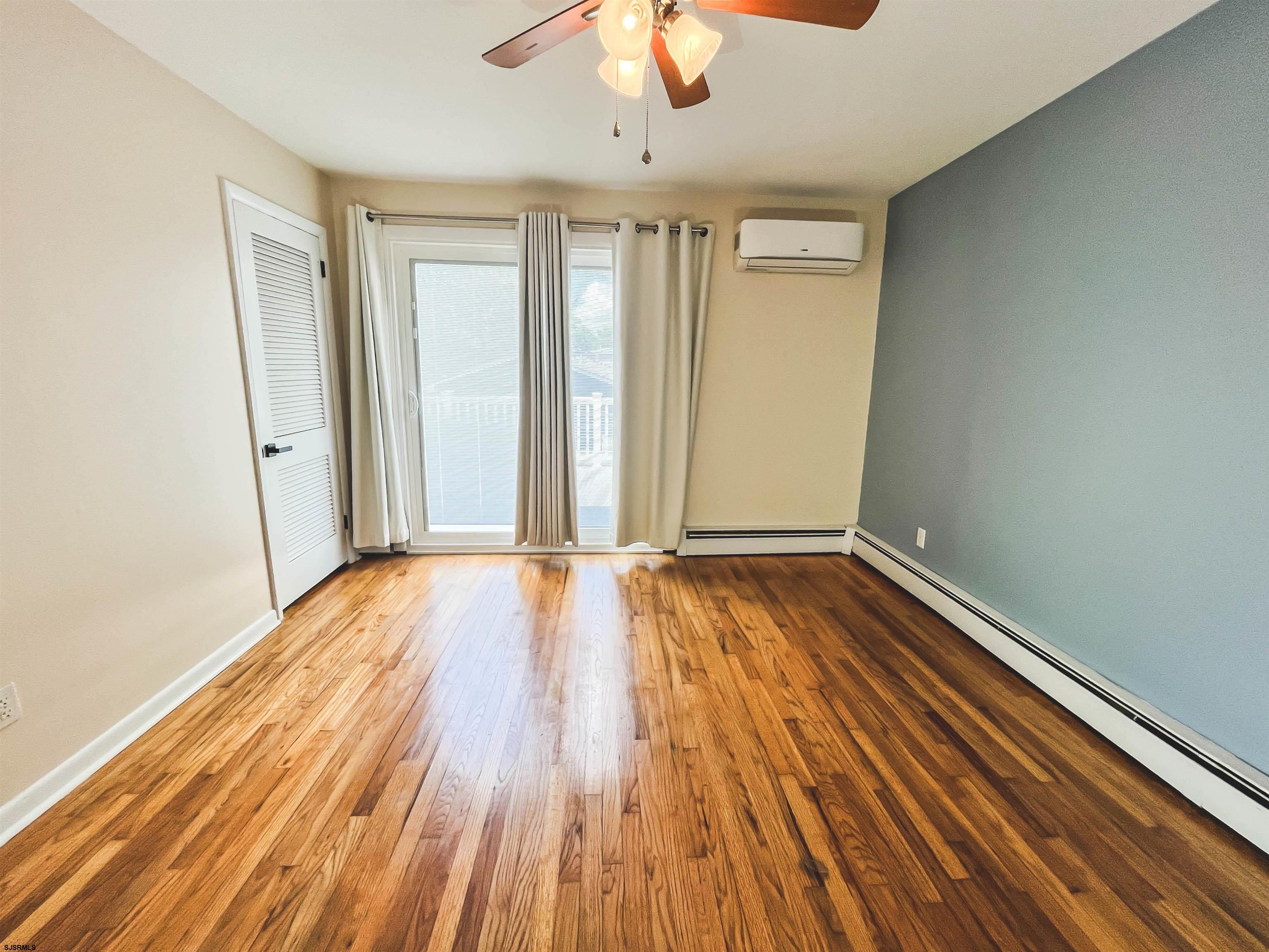 518 Delaware Avenue Absecon, NJ 08201 - Photo 17 of 38 wooden floor in an empty room with a window