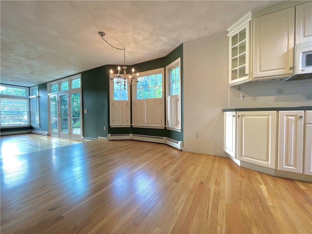 15 Jacobs Point Road Warren, RI 02885 - Photo 16 of 44 Large breakfast area that overlooks the rear yard is situated between the family room and kitchen