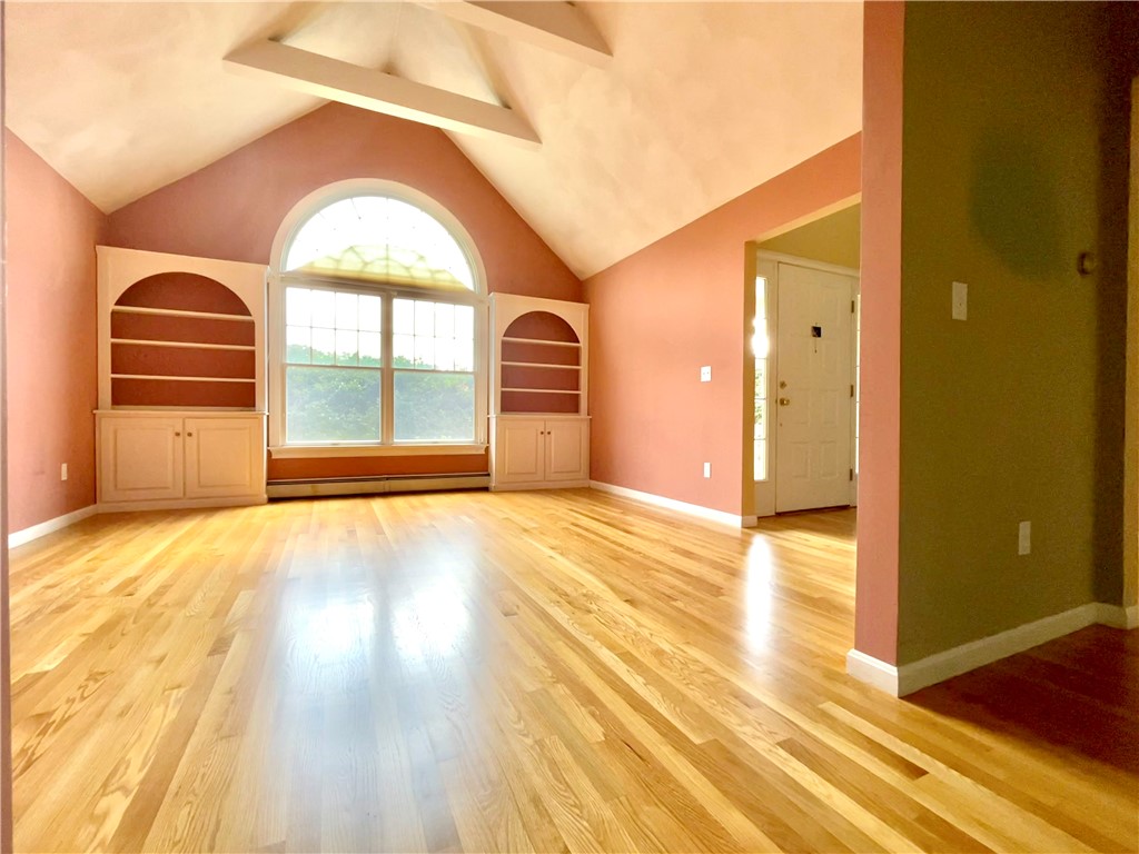 15 Jacobs Point Road Warren, RI 02885 - Photo 19 of 44 Vaulted living room with large windows that allows for tons of natural sunlight and gleaming hardwood floors that run through out the main level.