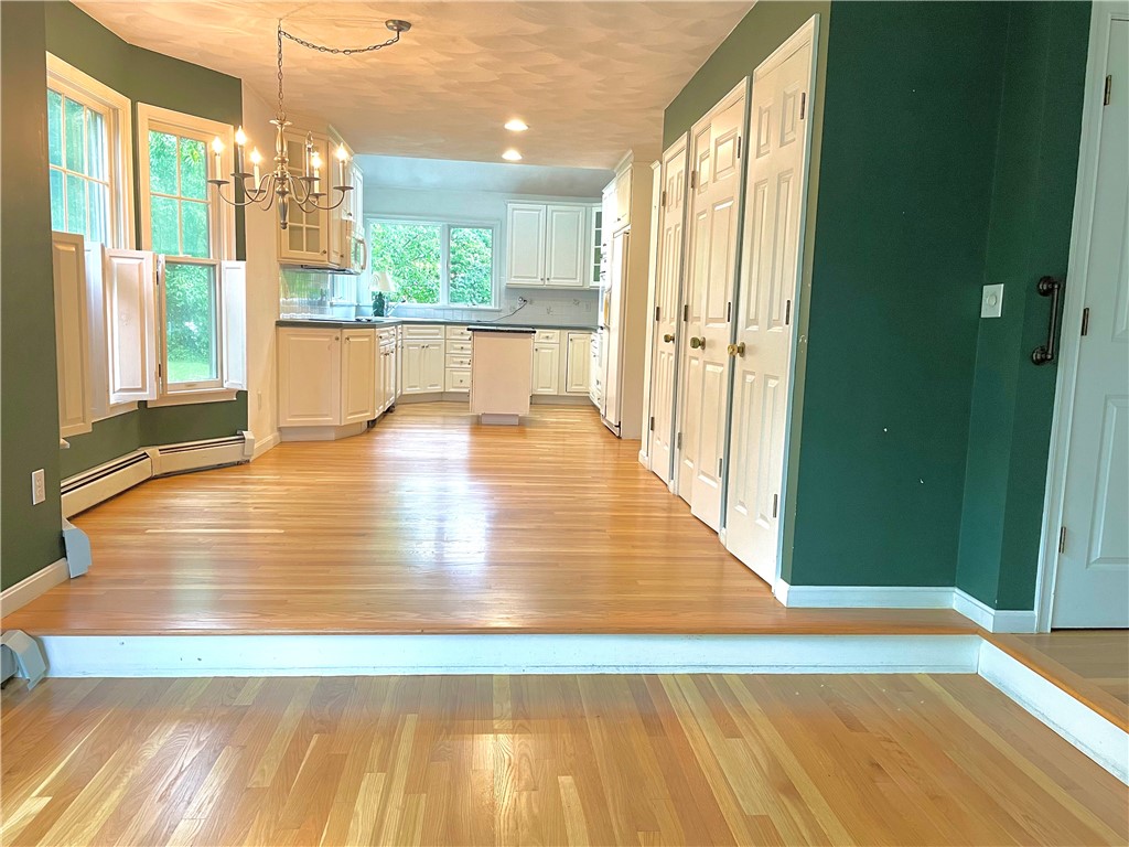 15 Jacobs Point Road Warren, RI 02885 - Photo 5 of 44 Front to back kitchen /dining area with sunny corner window. Easy rear deck access is located off the warm and inviting family room.