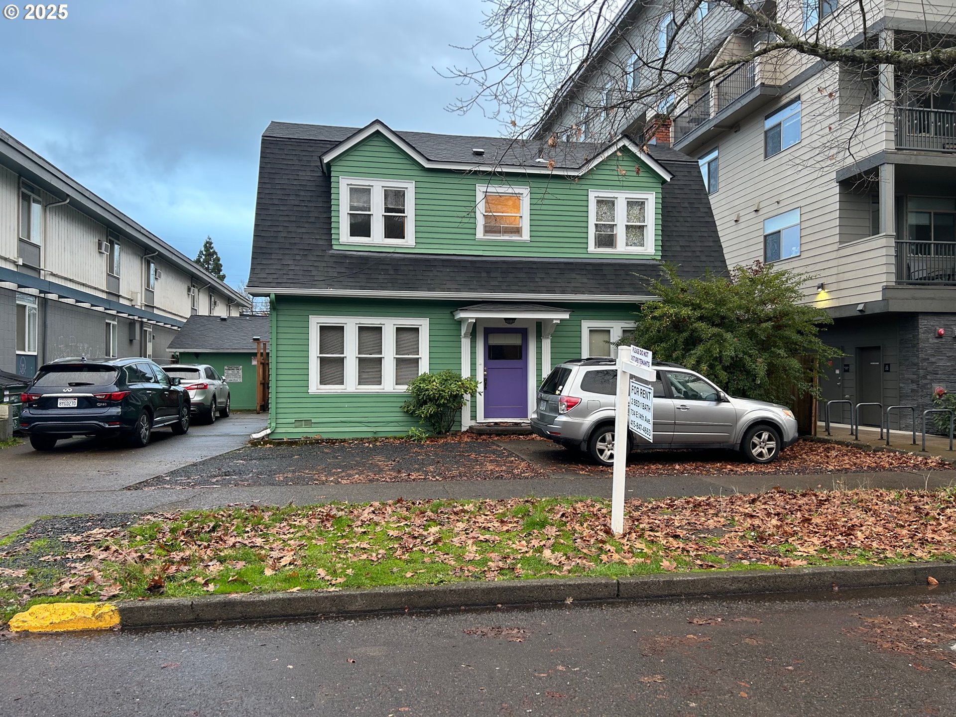 a car parked in front of a brick house