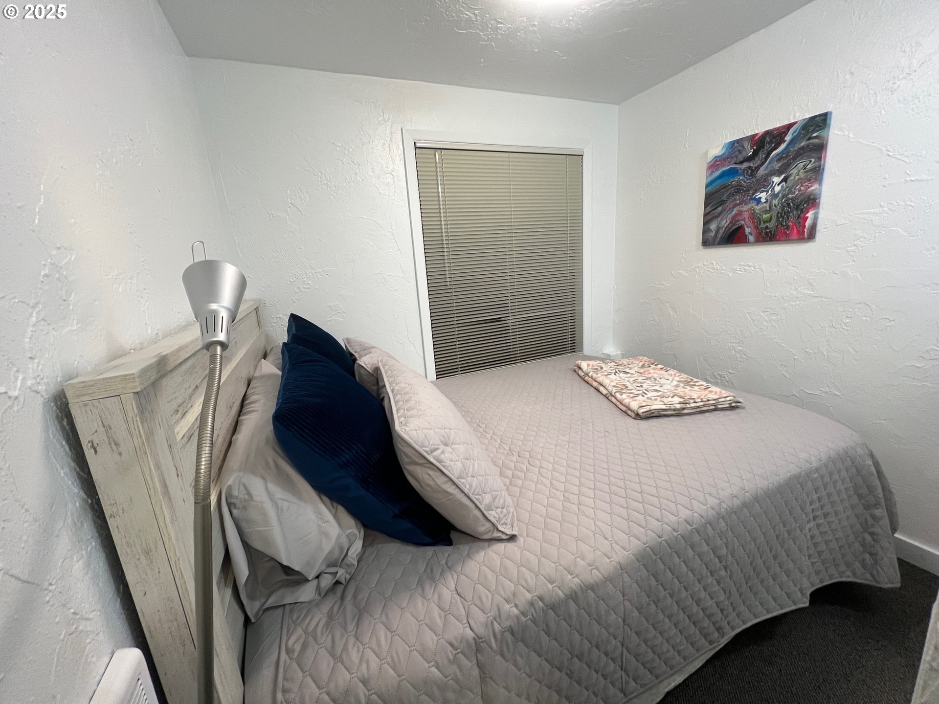 734 East 14th Avenue Eugene, OR 97401 - Photo 14 of 27 a bedroom with a bed and painting on the wall