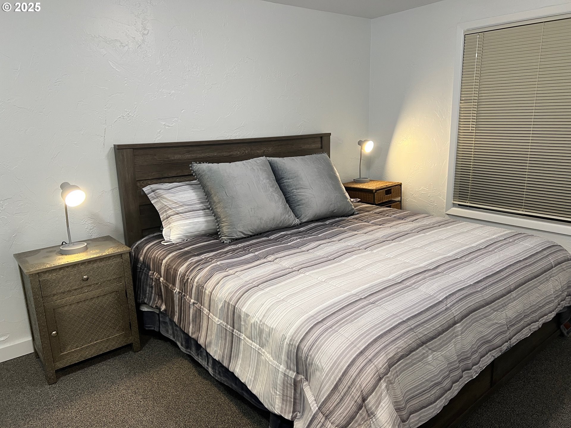 734 East 14th Avenue Eugene, OR 97401 - Photo 15 of 27 a bedroom with a bed and a lamp