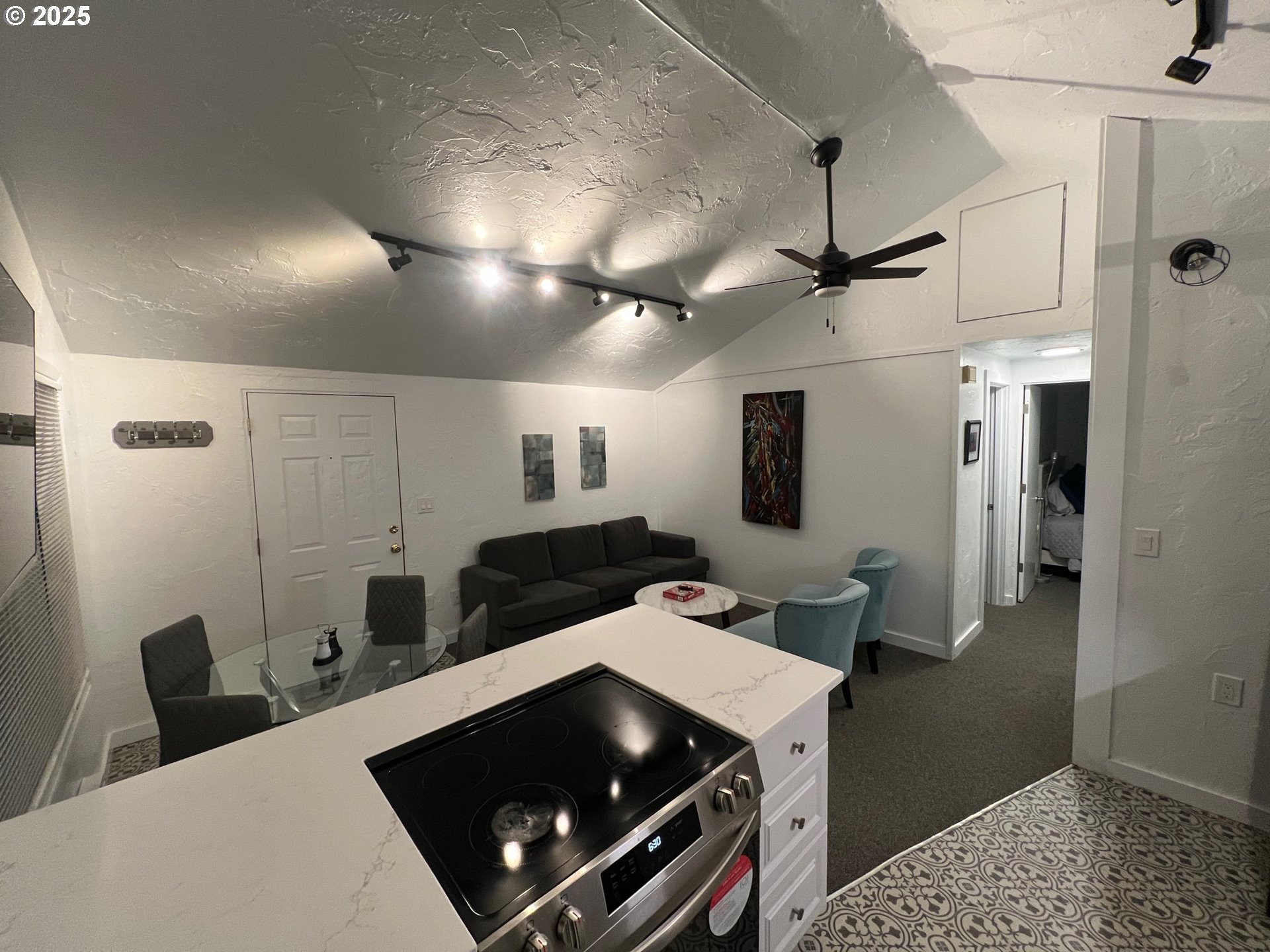 734 East 14th Avenue Eugene, OR 97401 - Photo 20 of 27 a kitchen with stainless steel appliances a stove a refrigerator a sink and white cabinets