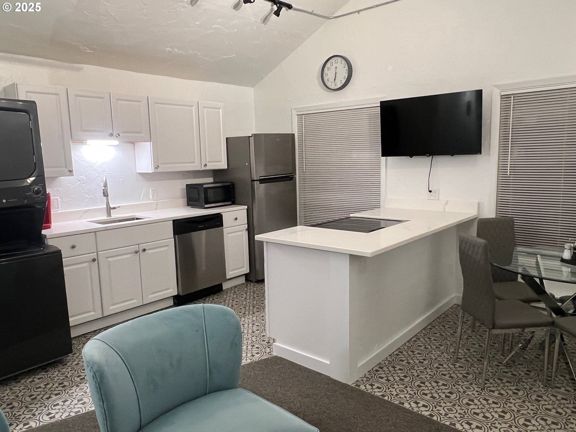 734 East 14th Avenue Eugene, OR 97401 - Photo 21 of 27 a kitchen with stainless steel appliances a stove a sink a microwave a refrigerator and cabinets