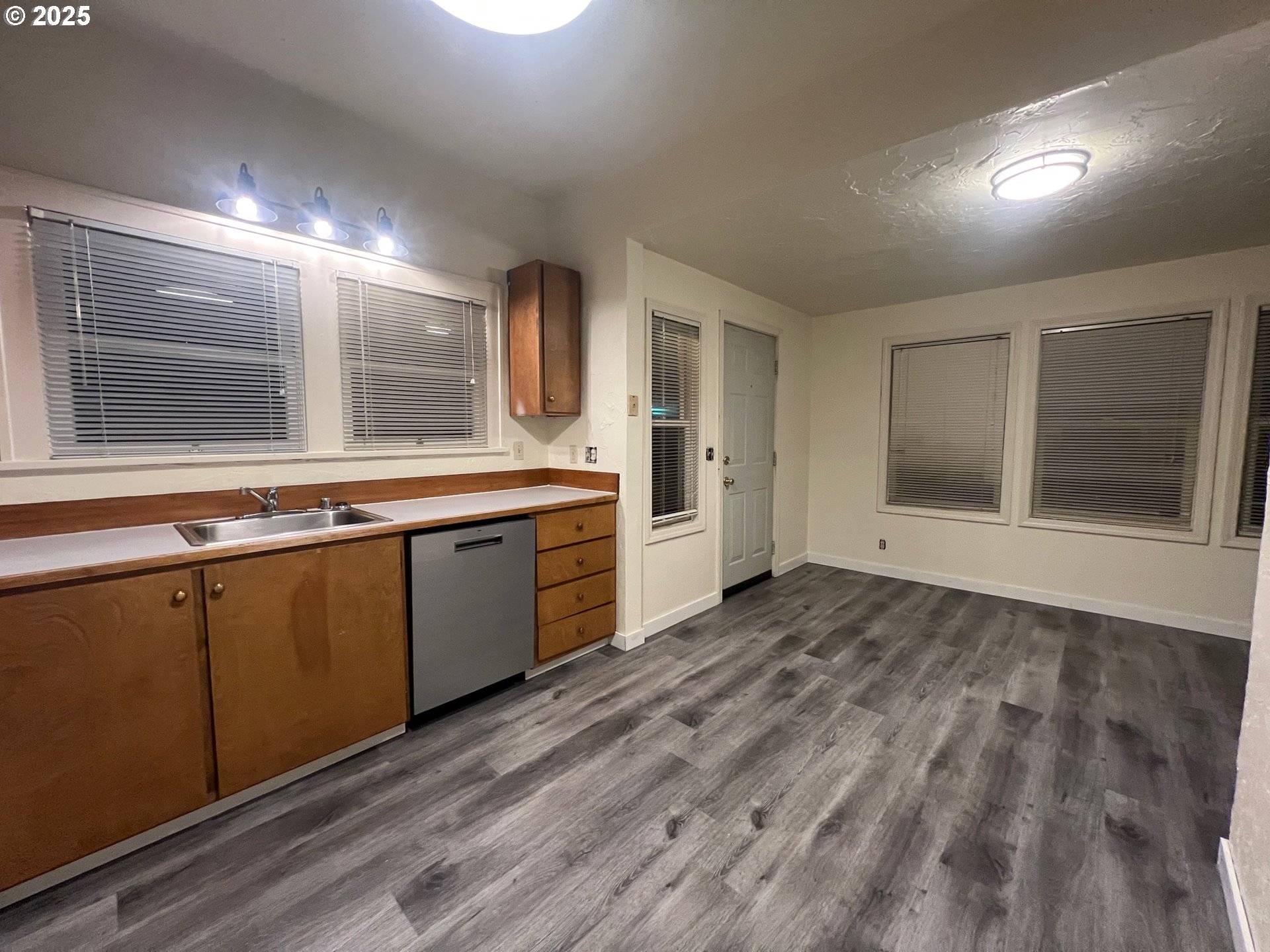 734 East 14th Avenue Eugene, OR 97401 - Photo 24 of 27 a view of a kitchen with a sink and dishwasher with wooden floor