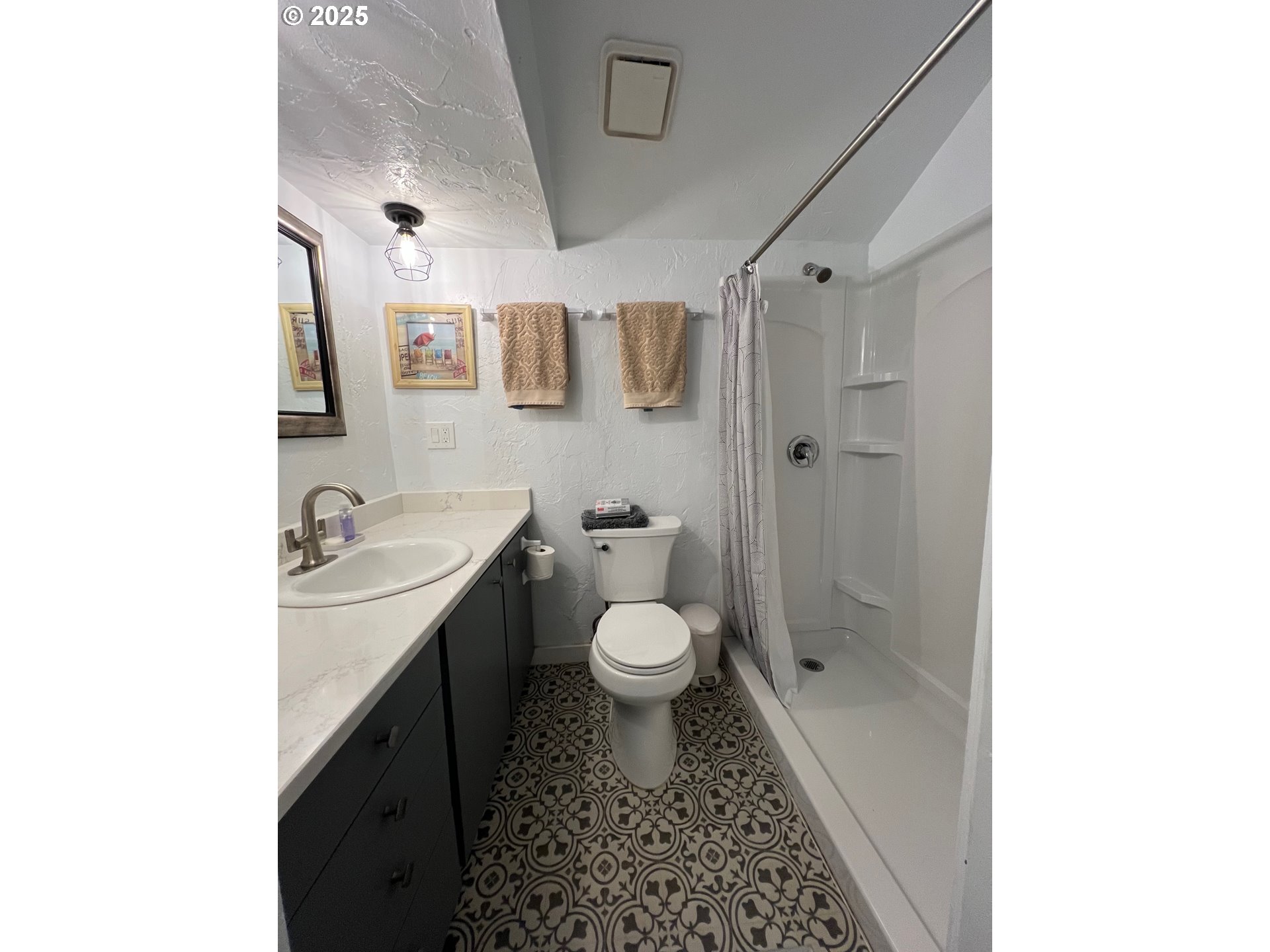 734 East 14th Avenue Eugene, OR 97401 - Photo 8 of 27 a bathroom with a granite countertop toilet sink and shower