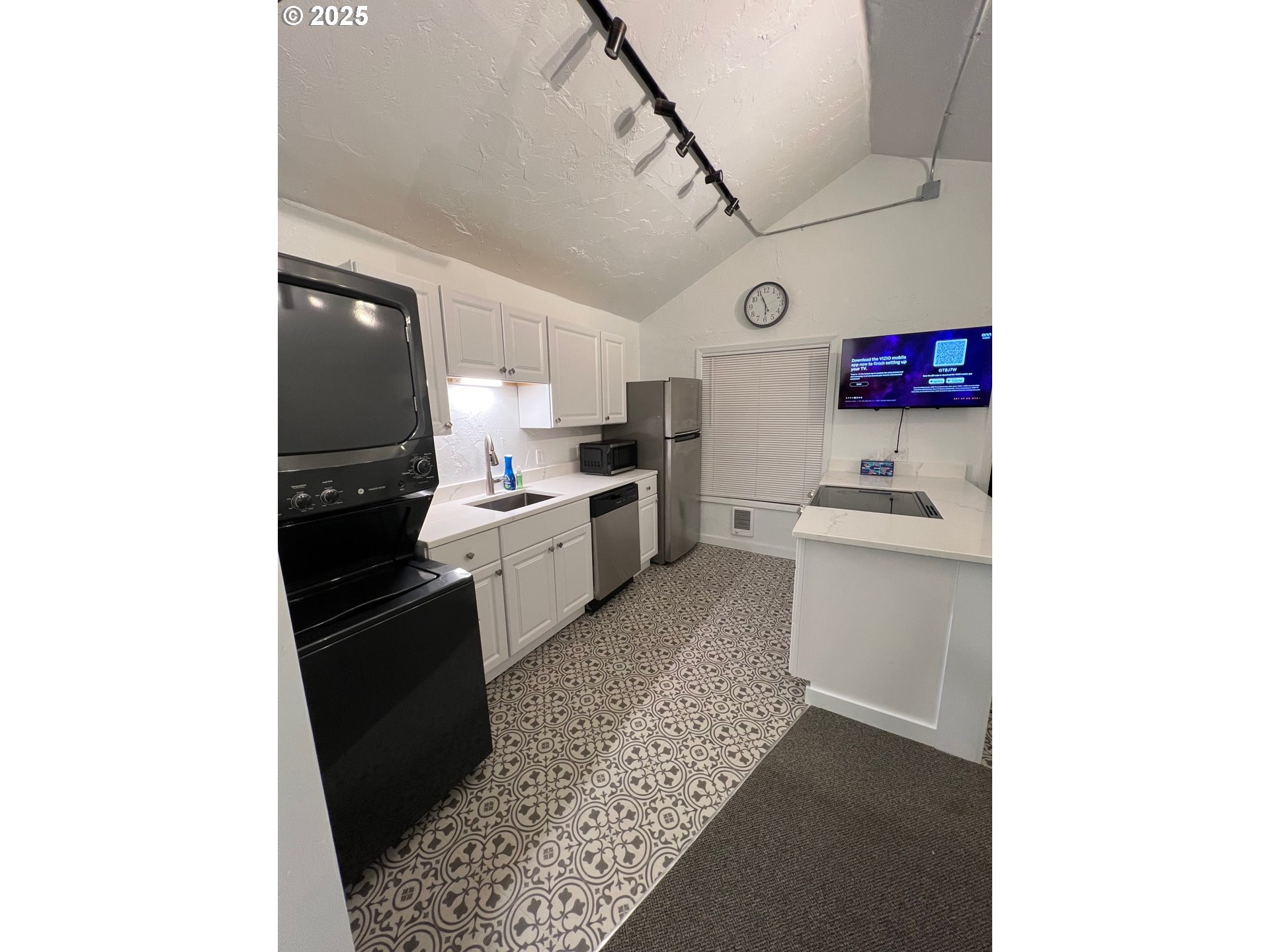 734 East 14th Avenue Eugene, OR 97401 - Photo 9 of 27 a kitchen with stainless steel appliances kitchen island granite countertop a sink and cabinets