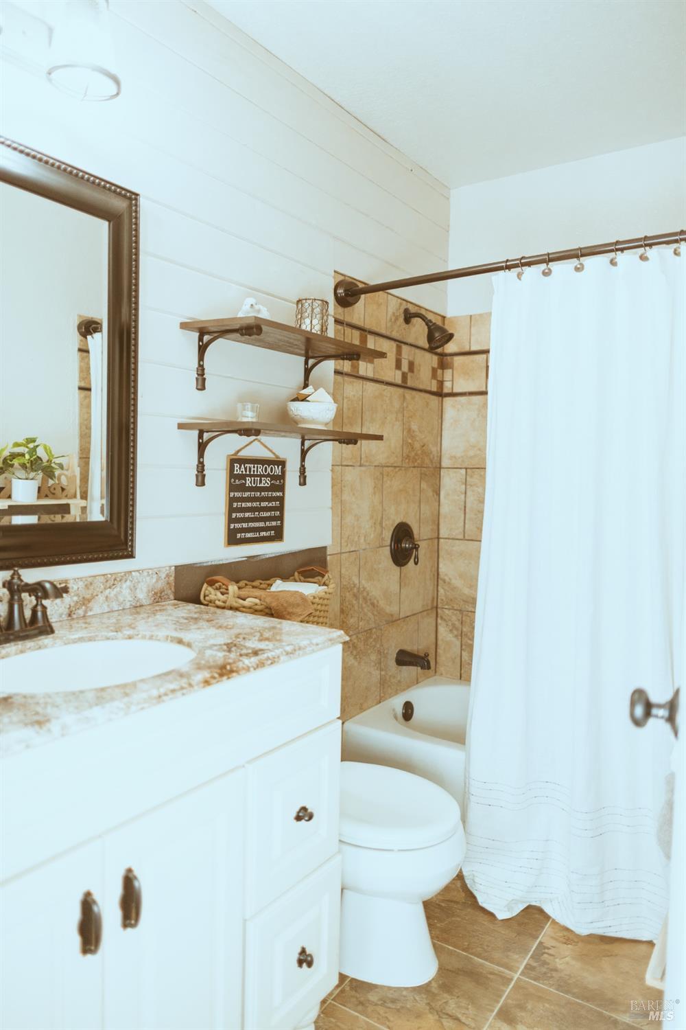 Undisclosed Address Rohnert Park, CA 94928 - Photo 19 of 38 a bathroom with a sink toilet a shower and a mirror