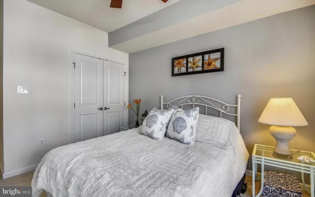 a bedroom with a bed and a painting on the wall