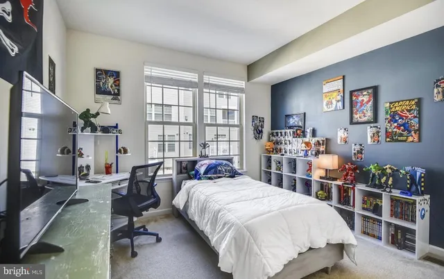 a bedroom with a bed a couch and a large window