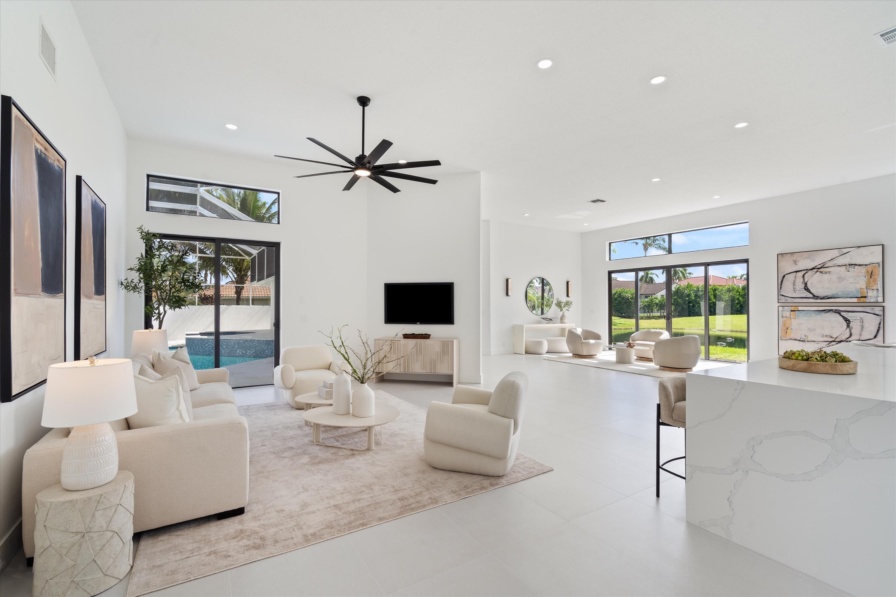 20209 Ocean Key Drive Boca Raton, FL 33498 - Photo 11 of 38 a living room with furniture a flat screen tv and a large window