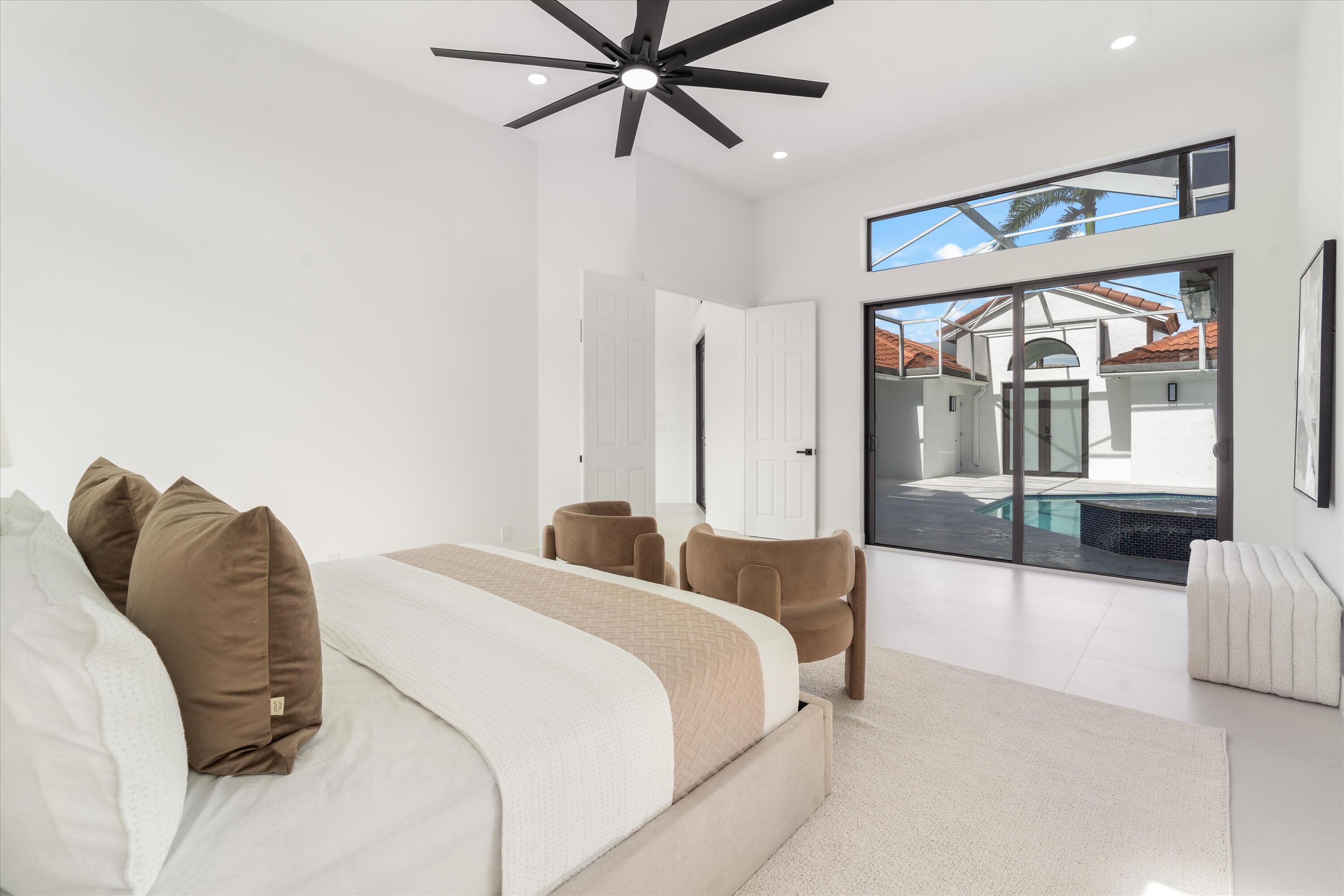 20209 Ocean Key Drive Boca Raton, FL 33498 - Photo 17 of 38 a bedroom with a bed and glass walk in closet
