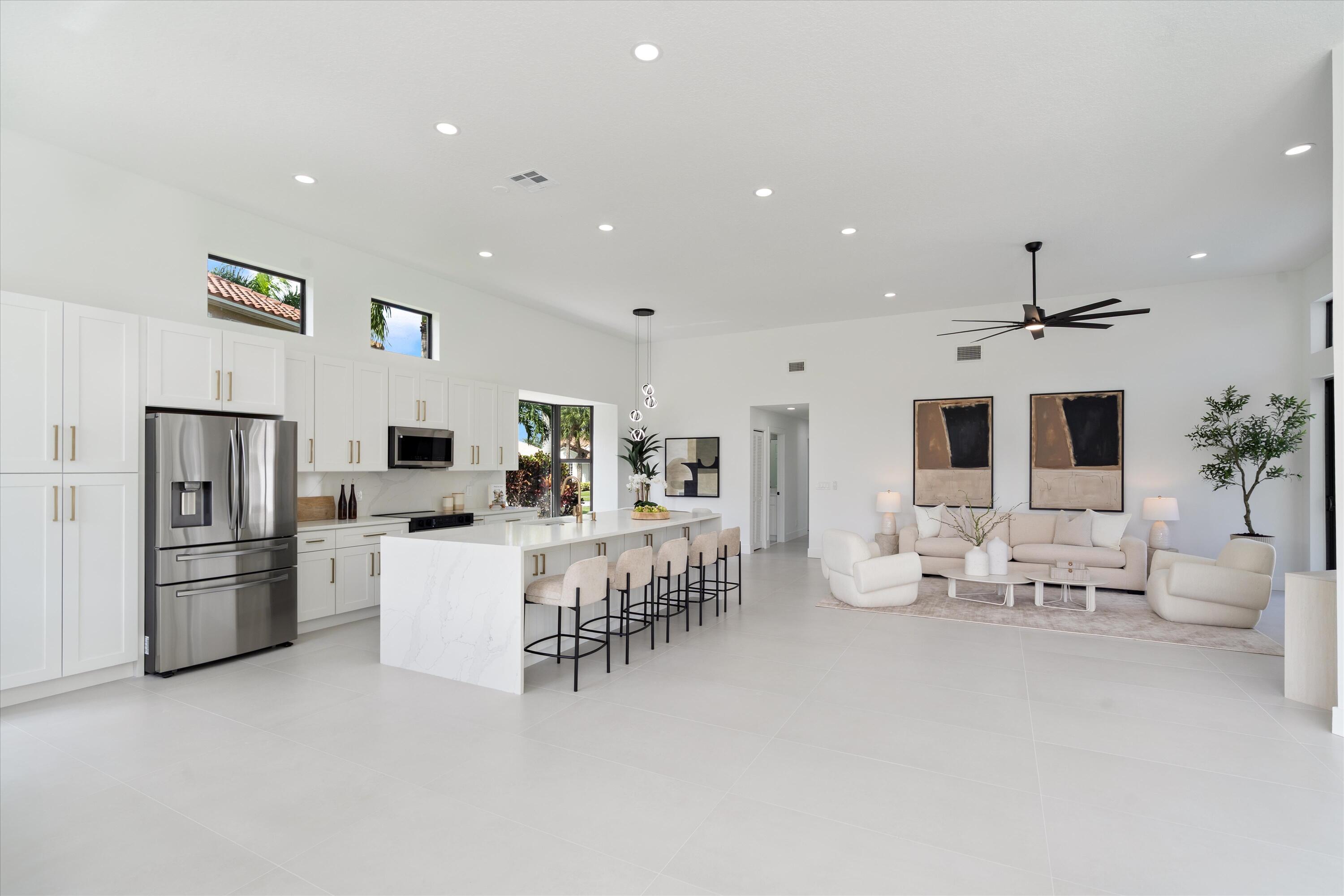 20209 Ocean Key Drive Boca Raton, FL 33498 - Photo 6 of 38 a living room with furniture a chandelier and a flat screen tv