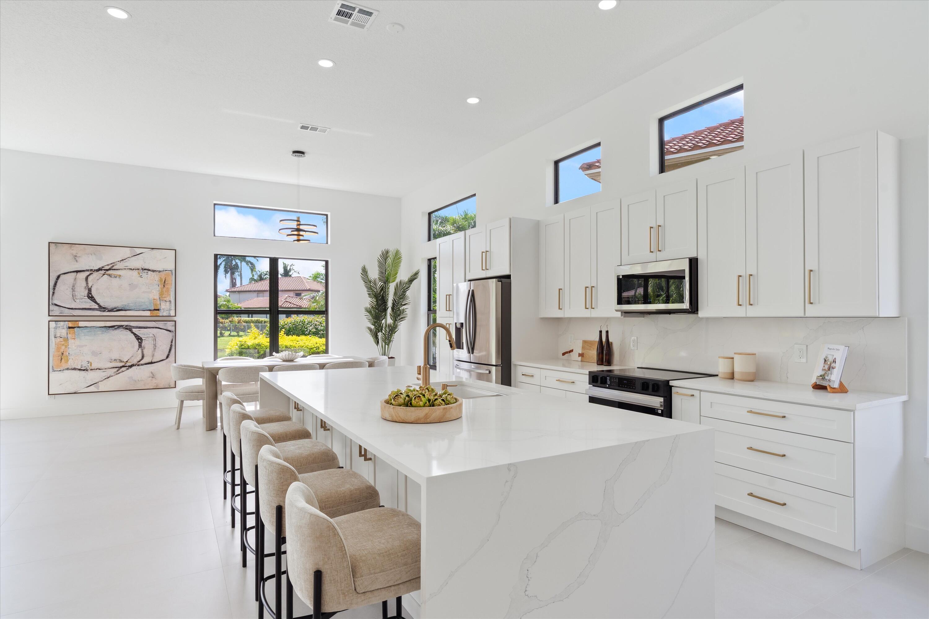 20209 Ocean Key Drive Boca Raton, FL 33498 - Photo 8 of 38 a kitchen with stainless steel appliances white cabinets and a refrigerator