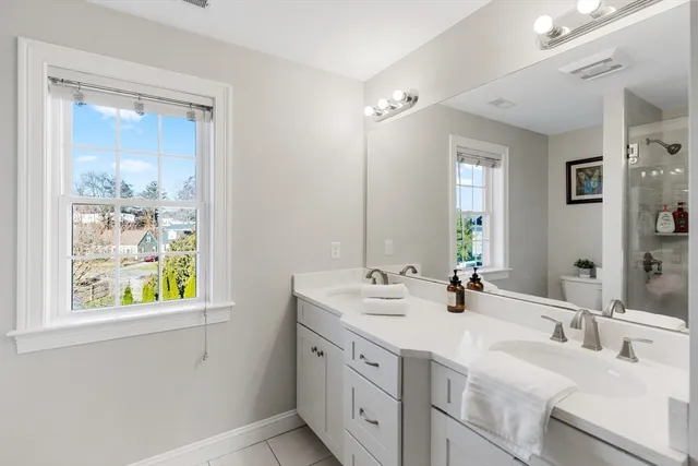 a bathroom with a sink vanity and a window