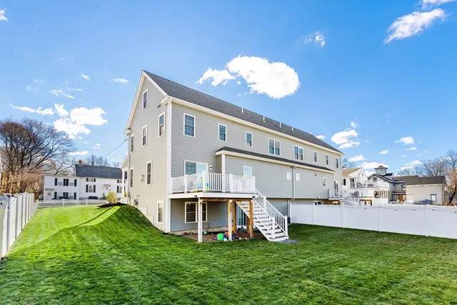 a view of a house with a yard and sitting area