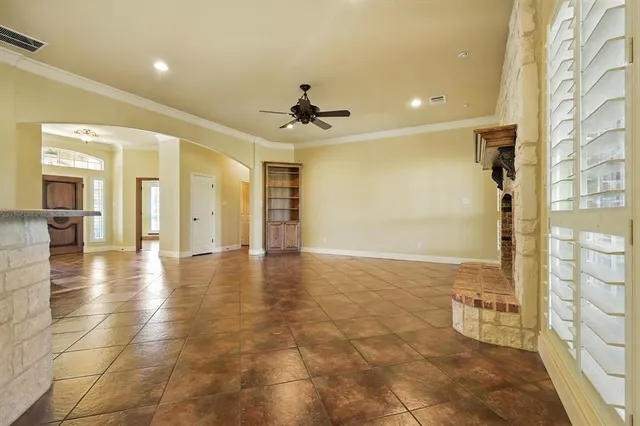 a view of a hallway with wooden floor and a kitchen