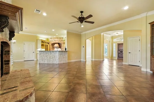 a view of a kitchen with kitchen island granite countertop a refrigerator cabinets and a stove