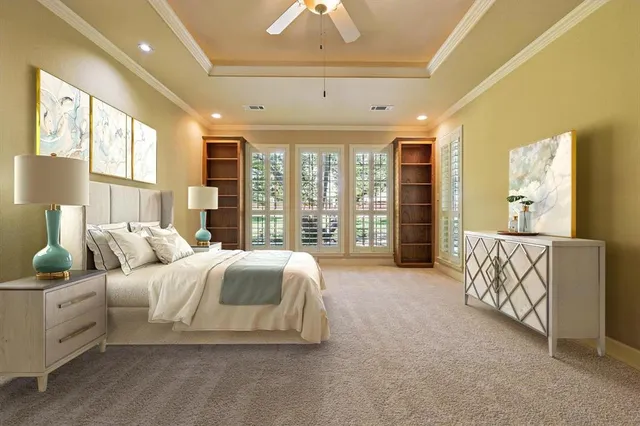 a spacious bedroom with a bed and glass walk in closet