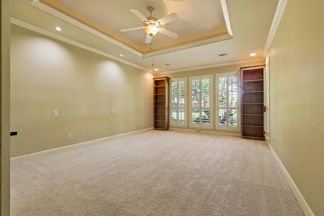 a view of an empty room and a ceiling fan
