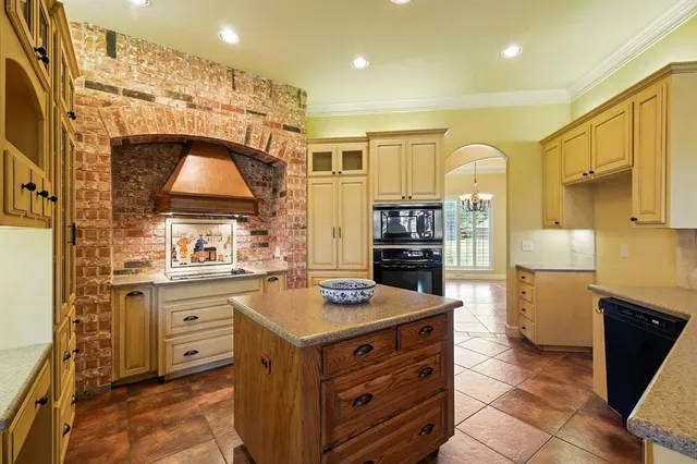 a kitchen that has a lot of cabinets in it and wooden floor
