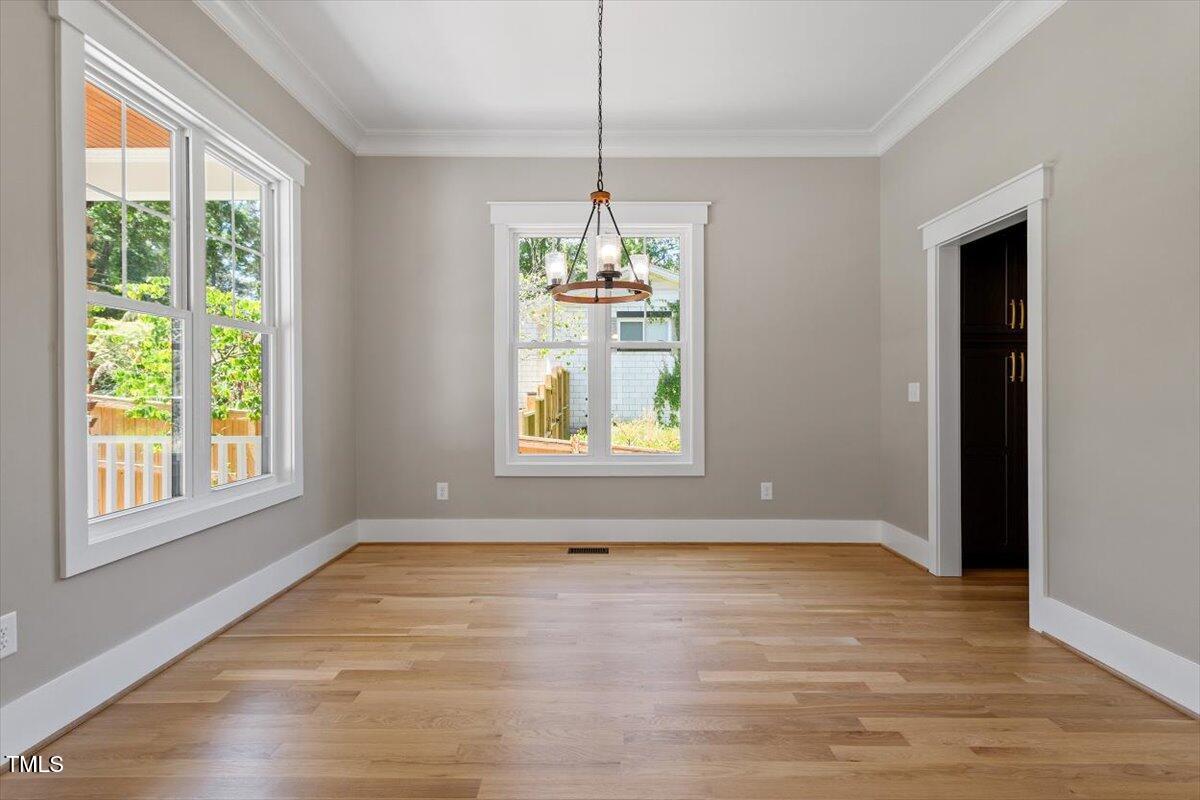 3934 Old Chapel Hill Road Durham, NC 27707 - Photo 14 of 47 a view of an empty room with wooden floor and a window