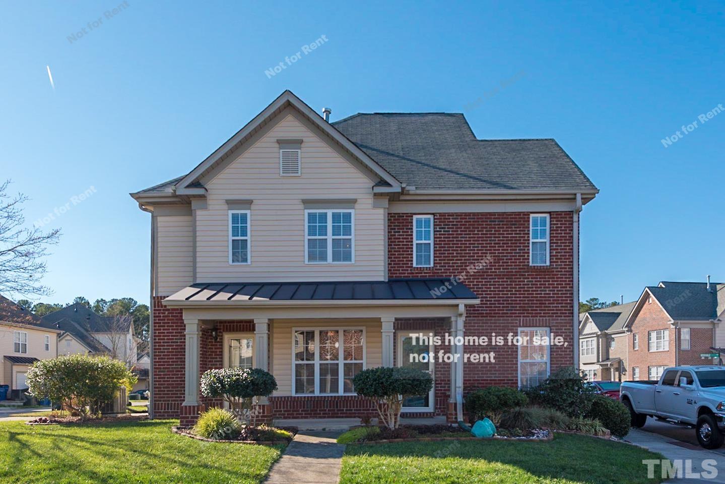 9801 Layla Avenue Raleigh, NC 27617 - Photo 1 of 17 a front view of a house with a yard and garage
