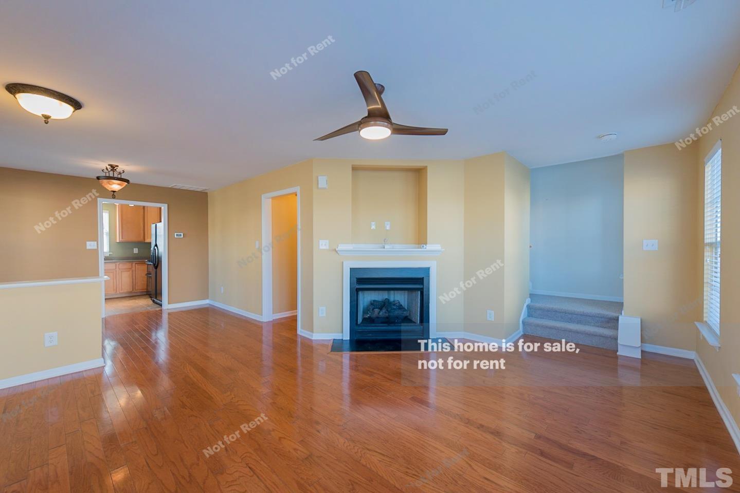 9801 Layla Avenue Raleigh, NC 27617 - Photo 11 of 17 a view of an empty room with wooden floor and a fireplace