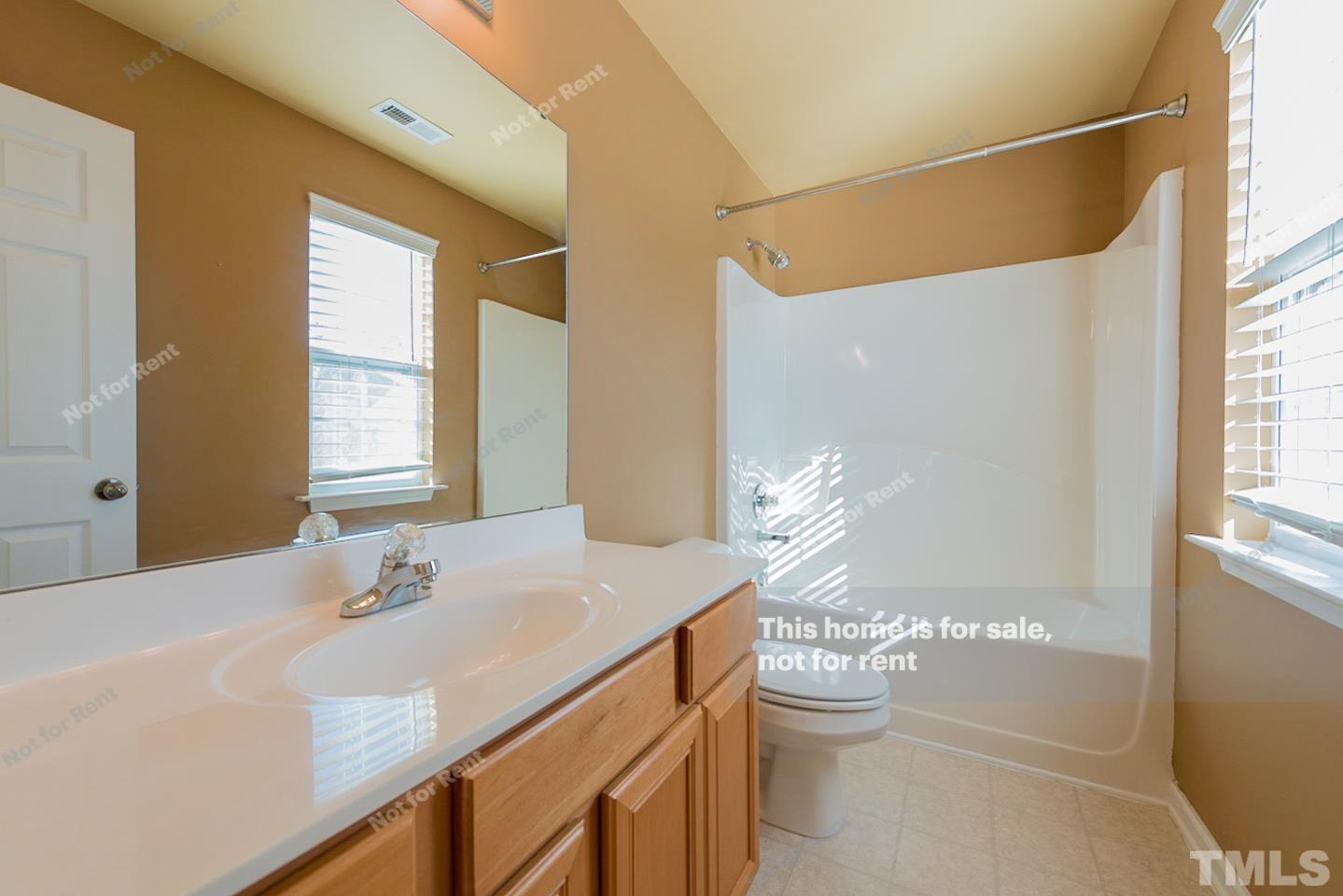 9801 Layla Avenue Raleigh, NC 27617 - Photo 16 of 17 a bathroom with a double vanity sink and a mirror