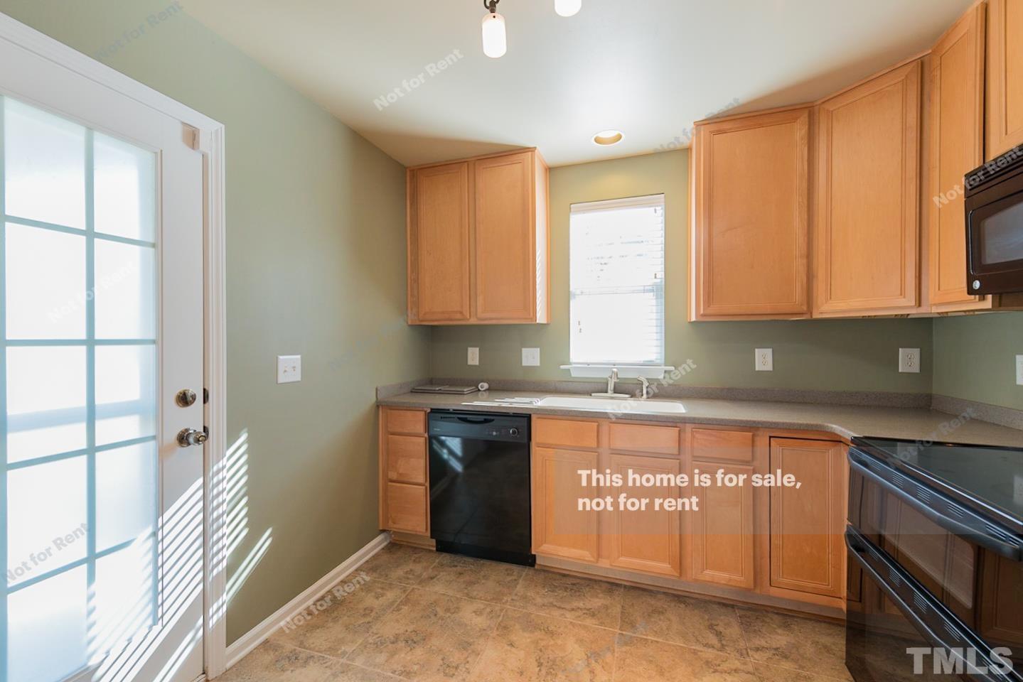 9801 Layla Avenue Raleigh, NC 27617 - Photo 4 of 17 a kitchen with stainless steel appliances granite countertop a stove a sink and a microwave
