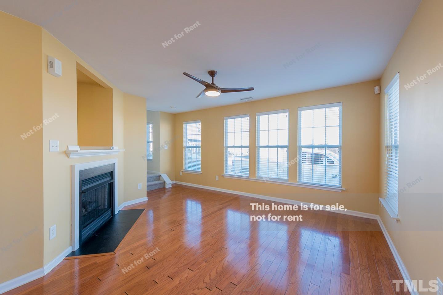 9801 Layla Avenue Raleigh, NC 27617 - Photo 5 of 17 a view of an empty room with a window and wooden floor