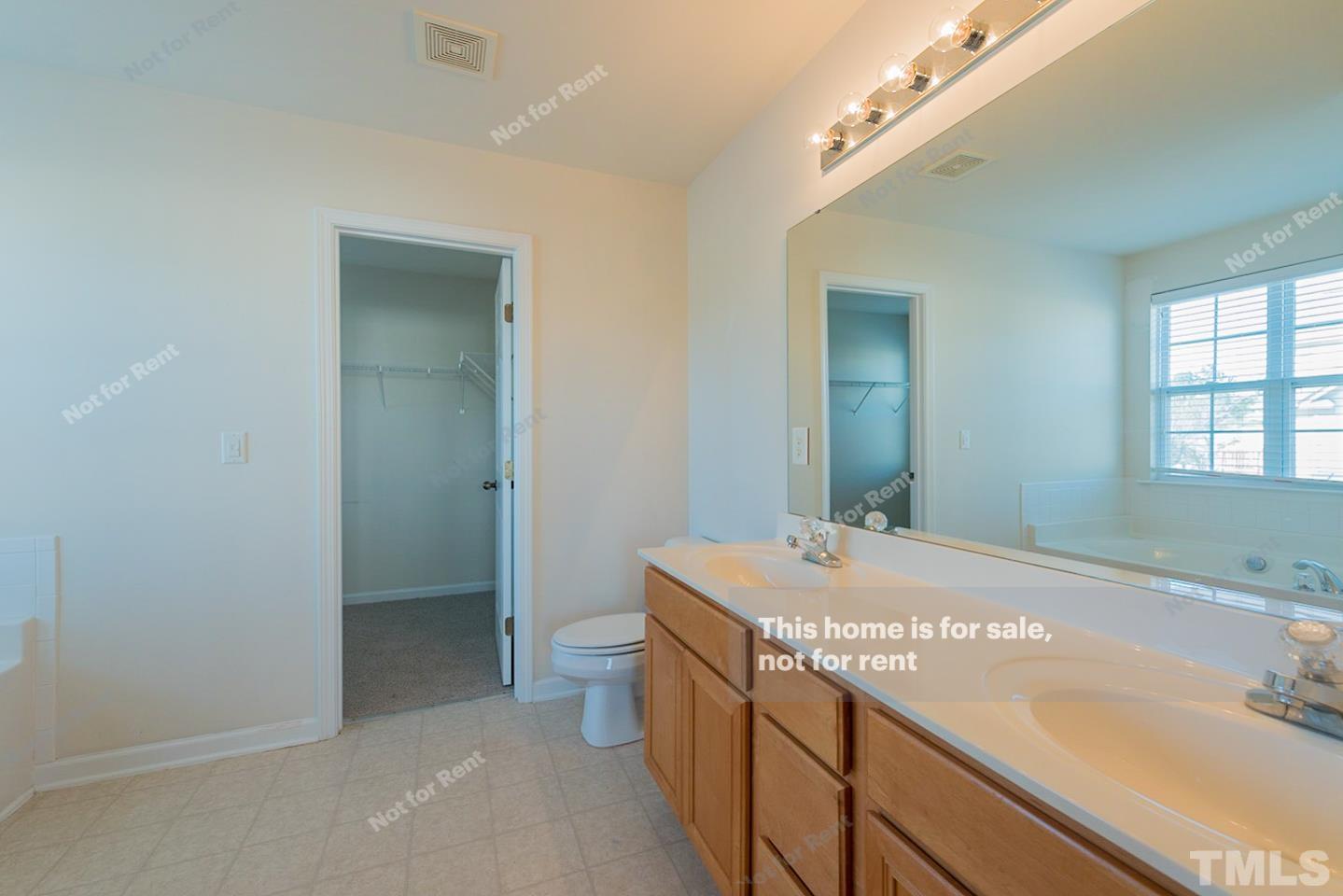 9801 Layla Avenue Raleigh, NC 27617 - Photo 6 of 17 a bathroom with a sink a toilet and shower