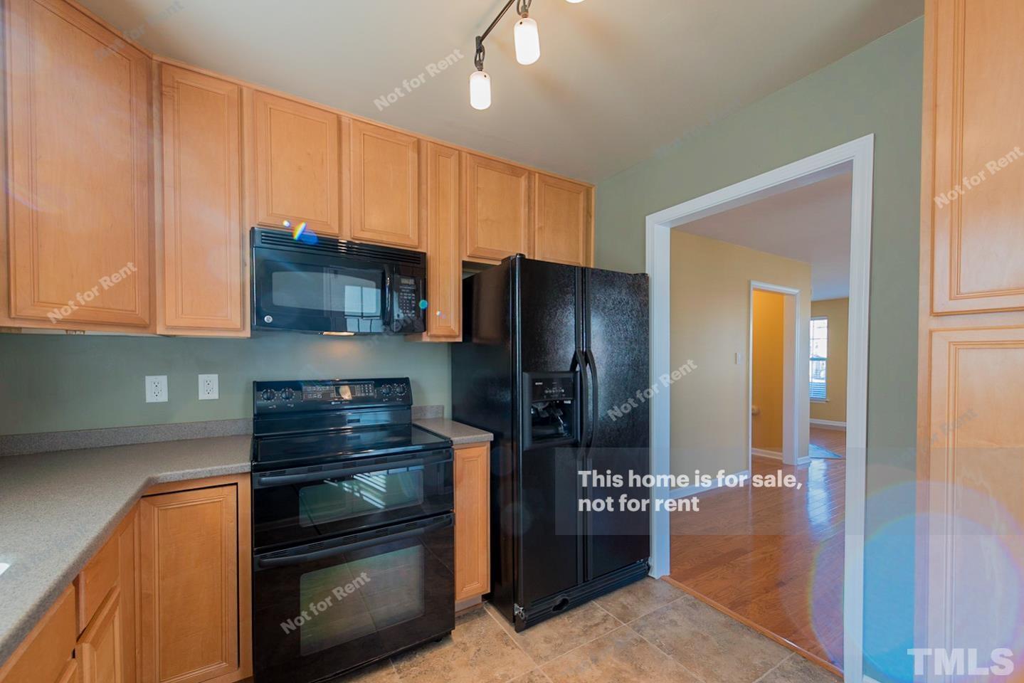 9801 Layla Avenue Raleigh, NC 27617 - Photo 8 of 17 a kitchen with stainless steel appliances a refrigerator and a stove top oven